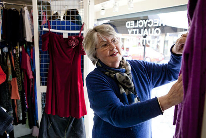 Volunteer merchandising stock in the brotherhood of St Laurence store in Ivanhoe